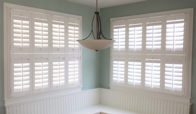 Pastel green wall in Denver kitchen with shutters.